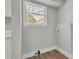 Bright laundry room with white trim, laminate flooring, and a large window at 556 Holly Nw St, Atlanta, GA 30318