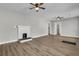 Open living room with hardwood floors, fireplace, and modern ceiling fans at 556 Holly Nw St, Atlanta, GA 30318