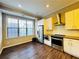 Modern kitchen with stainless steel appliances, white cabinetry, and dark wood floors at 557 Broadview Ne Pl, Atlanta, GA 30324