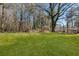 Beautifully landscaped backyard featuring a large yard and mature trees at 7256 Attache Way, Riverdale, GA 30296
