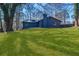 Beautifully landscaped backyard featuring a large yard and a home in the background at 7256 Attache Way, Riverdale, GA 30296