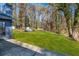 Spacious backyard features lush green lawn surrounded by mature trees, offering privacy and natural beauty at 7256 Attache Way, Riverdale, GA 30296