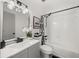 Full bathroom with black fixtures, gray vanity, white tile, tub, and shower with curtain at 7256 Attache Way, Riverdale, GA 30296