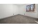 Bright bedroom featuring new carpet and a large window with a pleasant view of the outdoors at 7256 Attache Way, Riverdale, GA 30296