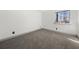 Bedroom featuring neutral paint, trim, and plush carpet, with a window view at 7256 Attache Way, Riverdale, GA 30296