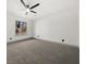 Large bedroom with new gray carpet, a large window, and a modern ceiling fan at 7256 Attache Way, Riverdale, GA 30296