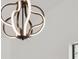 Close up of modern bronze colored chandelier with unique led design against white ceiling and partial wall at 7256 Attache Way, Riverdale, GA 30296