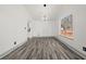 Bright dining room with wood-look floors and modern lighting fixture at 7256 Attache Way, Riverdale, GA 30296