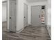 Inviting entryway with wood-look floors, neutral paint, and ample closet space at 7256 Attache Way, Riverdale, GA 30296