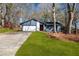 Charming single-story home with a well-maintained front yard and an attached two-car garage at 7256 Attache Way, Riverdale, GA 30296