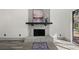 A stylish stone fireplace with a decorative mantel adds charm to the living space at 7256 Attache Way, Riverdale, GA 30296