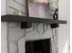 Close-up view of the stone fireplace with a wooden mantel and decorative accents at 7256 Attache Way, Riverdale, GA 30296