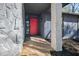 Close-up of the home's entrance featuring a bright red front door and stone accent wall at 7256 Attache Way, Riverdale, GA 30296