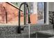 Close up of kitchen faucet with a black matte finish and gray speckled granite countertops near the sink at 7256 Attache Way, Riverdale, GA 30296