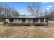 Ranch-style home with a covered front porch and mature trees in a rural setting at 9132 Brewer Rd, Villa Rica, GA 30180