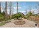 Expansive backyard with circular brick features and mature trees at 3620 Highpoint Rd, Cumming, GA 30041