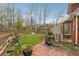 Well-maintained backyard with a brick patio, lush greenery, and a garden at 3620 Highpoint Rd, Cumming, GA 30041