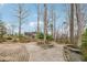 Beautiful backyard featuring stone benches, lush greenery, and a serene outdoor space at 3620 Highpoint Rd, Cumming, GA 30041