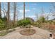 Serene backyard featuring stone benches, a circular garden, and lush surroundings at 3620 Highpoint Rd, Cumming, GA 30041