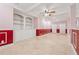 Finished basement area with built in cabinets, pink walls and red trim at 3620 Highpoint Rd, Cumming, GA 30041