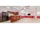 Finished basement wet bar with dark cabinetry, bar seating and a stainless refrigerator at 3620 Highpoint Rd, Cumming, GA 30041