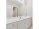 Bathroom with white vanity, white countertop, mirror, and tile floor at 3620 Highpoint Rd, Cumming, GA 30041