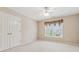 Bedroom with neutral carpet, double door closet and a window with valance and blinds at 3620 Highpoint Rd, Cumming, GA 30041