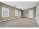 Bonus room features carpet and neutral walls with three windows at 3620 Highpoint Rd, Cumming, GA 30041