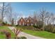 Beautiful two-story brick home with manicured front lawn and a long driveway at 3620 Highpoint Rd, Cumming, GA 30041