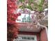 Exterior home detail showcasing a large arched window, red brick, and red leafed tree at 3620 Highpoint Rd, Cumming, GA 30041