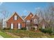 Beautiful brick home featuring a well-manicured lawn and classic architectural design at 3620 Highpoint Rd, Cumming, GA 30041