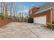 Driveway leading to a two-car garage, with brick exterior, and privacy fence at 3620 Highpoint Rd, Cumming, GA 30041