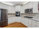 Well-equipped kitchen featuring granite countertops, a built-in oven, and modern appliances at 3620 Highpoint Rd, Cumming, GA 30041