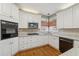 Traditional kitchen with white cabinets, granite counters, tile backsplash, stainless appliances, and hardwood floors at 3620 Highpoint Rd, Cumming, GA 30041