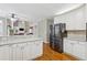 Open kitchen with granite countertops, white cabinets, and stainless steel appliances at 3620 Highpoint Rd, Cumming, GA 30041