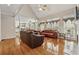 Bright living room boasts vaulted ceilings, hardwood floors, and comfortable leather furnishings at 3620 Highpoint Rd, Cumming, GA 30041