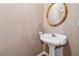 A pedestal sink with an antique gold mirror in a powder room at 3620 Highpoint Rd, Cumming, GA 30041