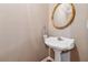 Powder room features a pedestal sink and decorative mirror at 3620 Highpoint Rd, Cumming, GA 30041