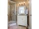 Bathroom featuring a glass-enclosed shower and a granite-topped vanity at 5029 Tarry Glen Dr, Suwanee, GA 30024