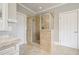 Modern bathroom featuring glass shower enclosure, neutral tile, and ample vanity space at 5029 Tarry Glen Dr, Suwanee, GA 30024