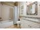 Bathroom boasts a vanity with granite countertop, bathtub, and a shower at 5029 Tarry Glen Dr, Suwanee, GA 30024