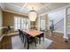 Elegant dining room with coffered ceiling, chandelier, and hardwood floors at 5029 Tarry Glen Dr, Suwanee, GA 30024