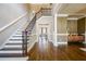 Spacious foyer with hardwood floors, staircase, and a glimpse into the living room at 5029 Tarry Glen Dr, Suwanee, GA 30024