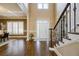 Bright foyer featuring a staircase, hardwood floors, and coffered ceilings at 5029 Tarry Glen Dr, Suwanee, GA 30024