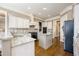 Kitchen featuring an island, granite counters, stainless appliances, and custom cabinetry at 5029 Tarry Glen Dr, Suwanee, GA 30024