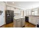 Kitchen features stainless steel refrigerator, center island, and modern appliances at 5029 Tarry Glen Dr, Suwanee, GA 30024