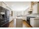 Updated kitchen featuring granite countertops, stainless steel appliances, and custom cabinetry at 5029 Tarry Glen Dr, Suwanee, GA 30024