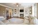 Bright living room featuring hardwood floors, fireplace, built-in shelves, and comfortable seating at 5029 Tarry Glen Dr, Suwanee, GA 30024