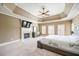 Comfortable primary bedroom with carpet, fireplace, tray ceiling, and serene ambiance at 5029 Tarry Glen Dr, Suwanee, GA 30024