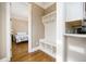 Mud room and a view into a bedroom with hardwood floors and white trim at 5029 Tarry Glen Dr, Suwanee, GA 30024